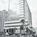 Grayscale Photo of City Buildings and Cars on Road